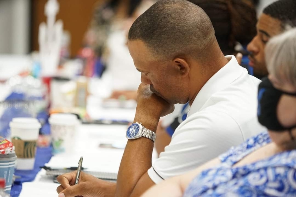 Coach James Shaw taking notes